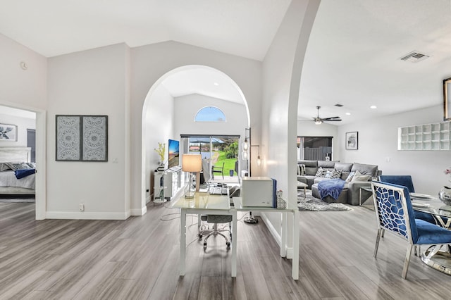 interior space featuring light wood-type flooring, high vaulted ceiling, and ceiling fan