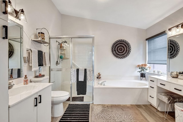 full bathroom with separate shower and tub, wood-type flooring, toilet, vaulted ceiling, and vanity