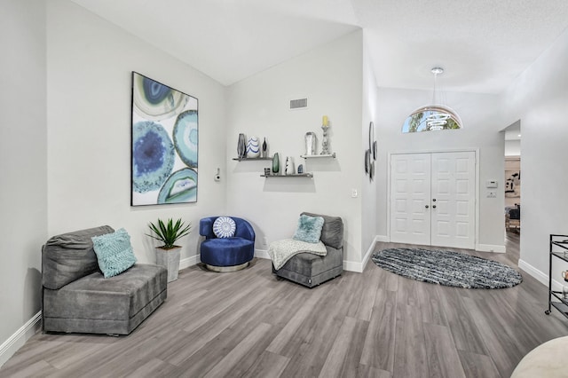 entrance foyer with light hardwood / wood-style floors and vaulted ceiling