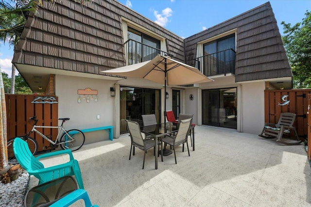 back of house with a balcony and a patio area