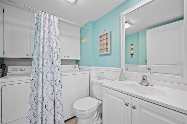 bathroom featuring washer / clothes dryer, vanity, a shower with shower curtain, and toilet