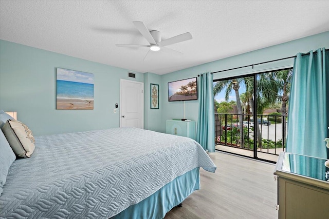 bedroom with access to exterior, light hardwood / wood-style flooring, a textured ceiling, and ceiling fan