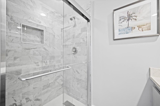 bathroom with vanity and a shower with shower door