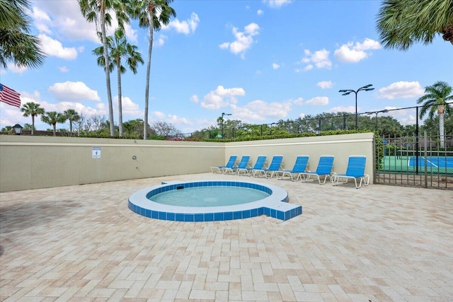 view of pool with a hot tub