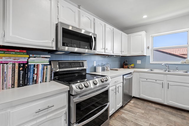 4316 S Ocean Blvd Unit 2S, Highland Beach, FL 33487 - kitchen with appliances with stainless steel finishes, a sink, white cabinetry, light countertops, and recessed lighting