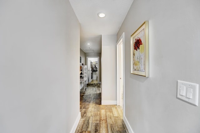 hall featuring wood-type flooring and a textured ceiling