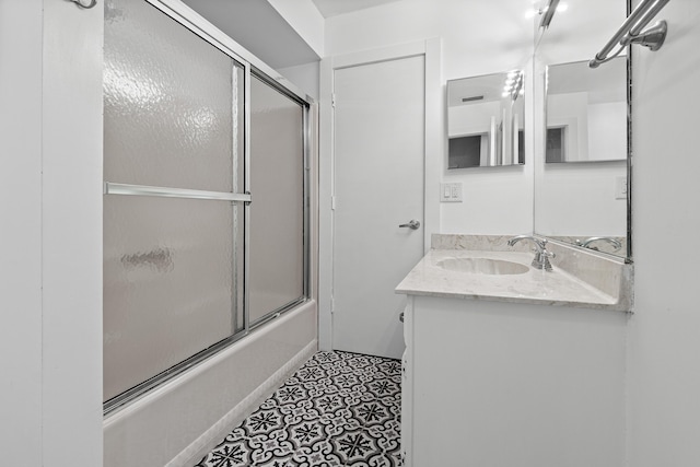 4316 S Ocean Blvd Unit 2S, Highland Beach, FL 33487 - bathroom featuring bath / shower combo with glass door, vanity, and tile patterned flooring