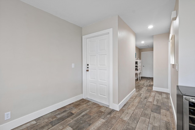 4316 S Ocean Blvd Unit 2S, Highland Beach, FL 33487 - hall with baseboards, light wood finished floors, beverage cooler, and recessed lighting