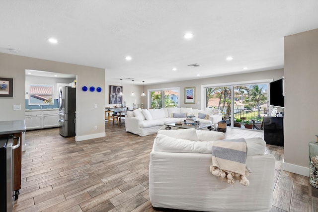 4316 S Ocean Blvd Unit 2S, Highland Beach, FL 33487 - living area featuring recessed lighting, wood finished floors, and baseboards