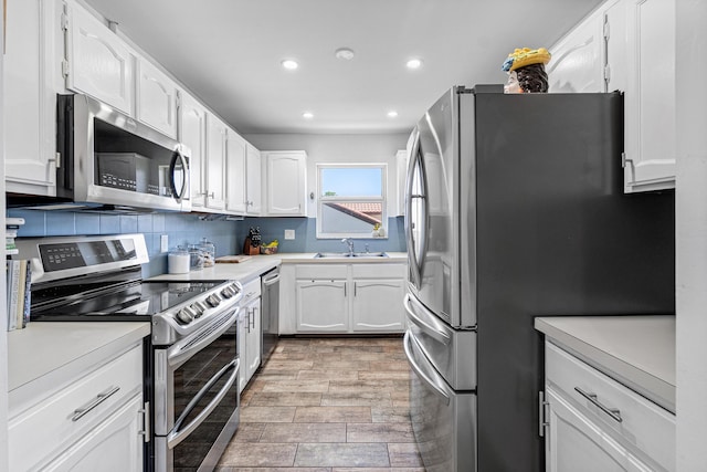 4316 S Ocean Blvd Unit 2S, Highland Beach, FL 33487 - kitchen featuring appliances with stainless steel finishes, recessed lighting, white cabinetry, a sink, and light countertops