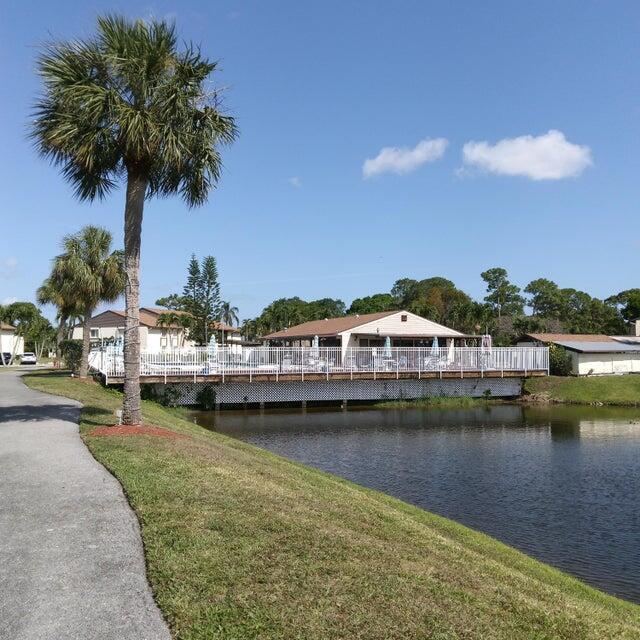 dock area featuring a water view and a yard