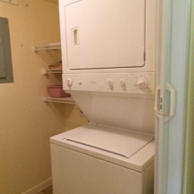 washroom with laundry area and stacked washer / dryer