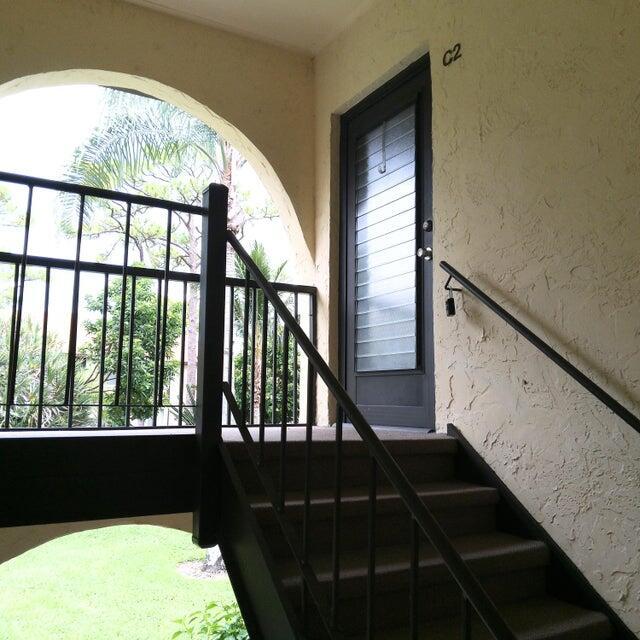 stairway with a wealth of natural light and a textured wall