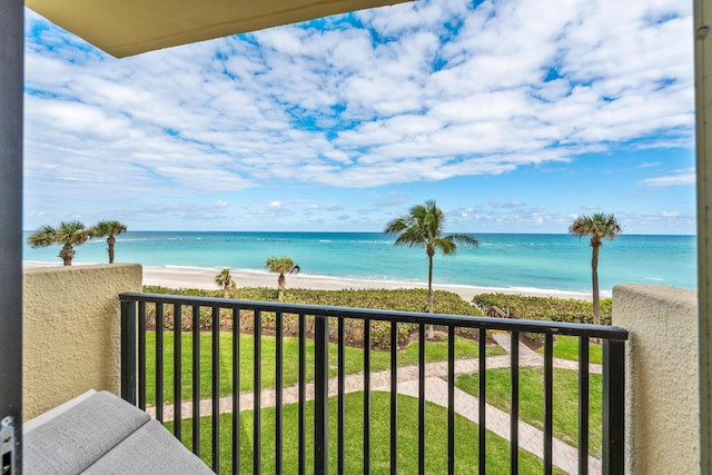 balcony with a water view and a beach view