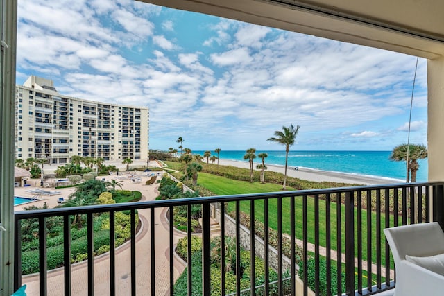 balcony featuring a beach view and a water view