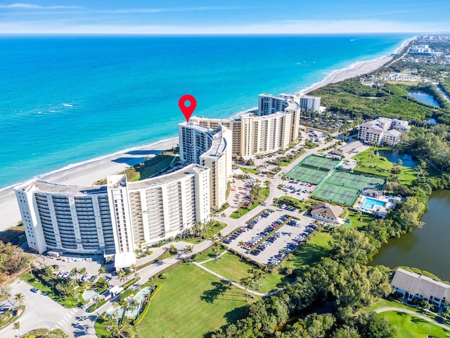 aerial view with a city view, a view of the beach, and a water view