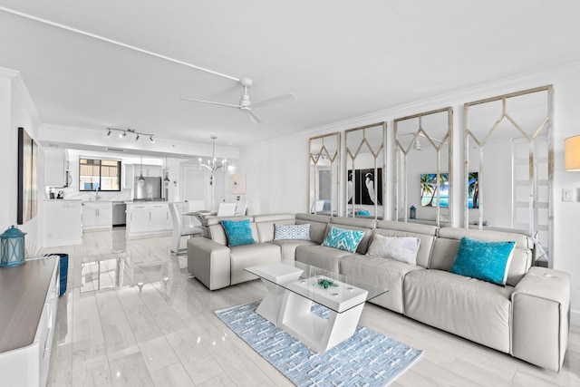 living area featuring ornamental molding and ceiling fan with notable chandelier