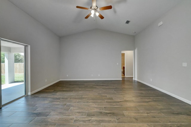 spare room featuring dark wood-type flooring, ceiling fan, and vaulted ceiling