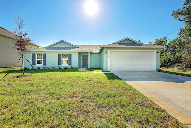 ranch-style house with a garage and a front lawn