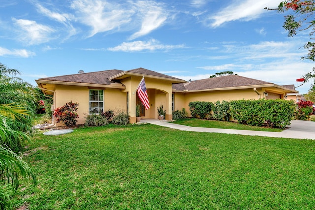 view of front of property featuring a garage, concrete driveway, a front lawn, and stucco siding