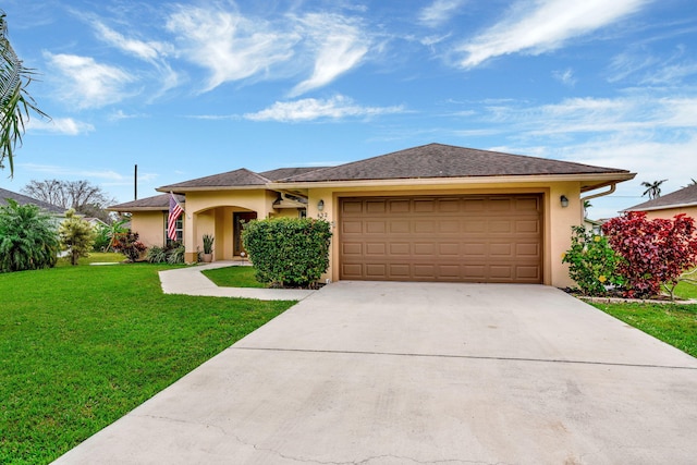 view of front of property featuring a garage, stucco siding, concrete driveway, and a front yard