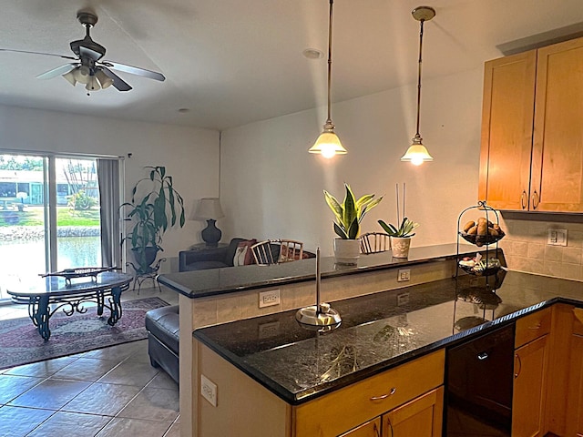 kitchen with hanging light fixtures, decorative backsplash, ceiling fan, dark stone countertops, and a peninsula