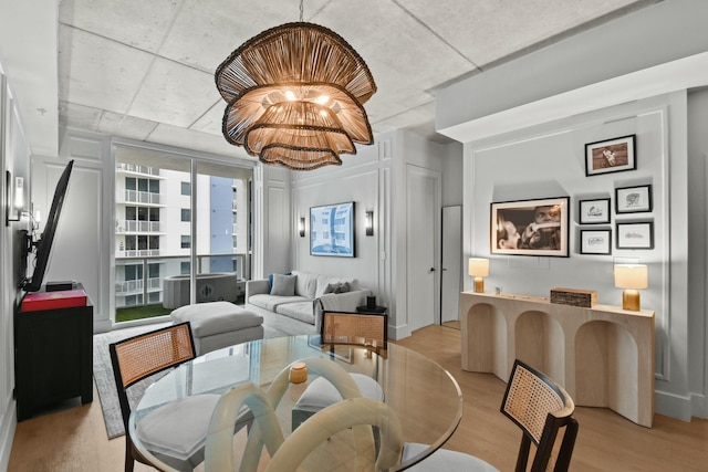 dining area featuring a chandelier and light wood-type flooring