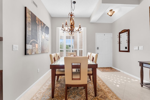 dining space with an inviting chandelier, tile patterned flooring, visible vents, and baseboards