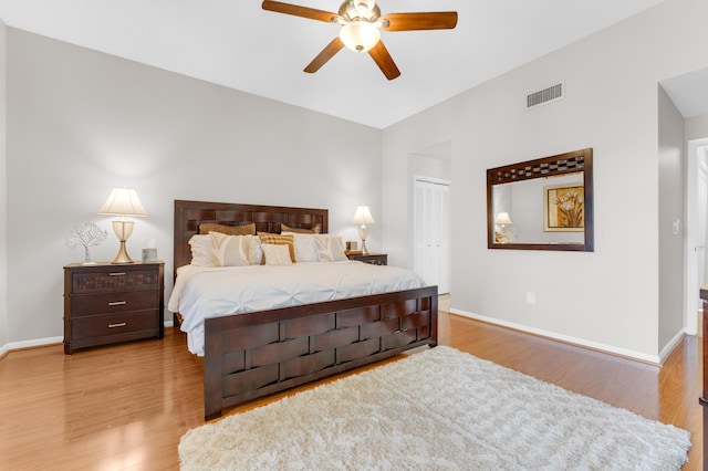 bedroom featuring light hardwood / wood-style floors, a closet, and ceiling fan