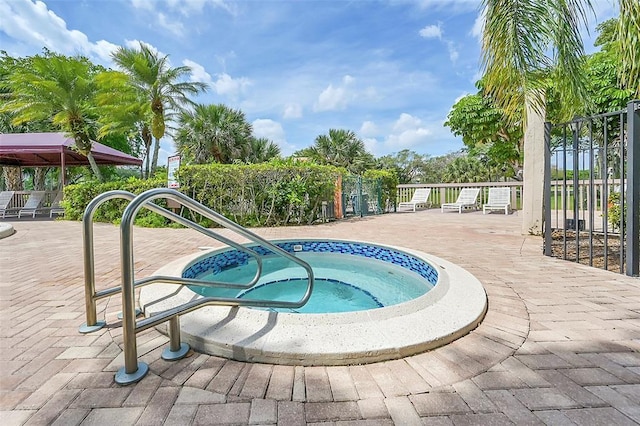 view of swimming pool featuring a patio area and a community hot tub