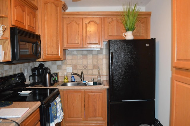 kitchen featuring tasteful backsplash, sink, and black appliances