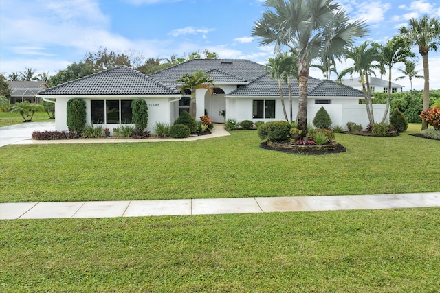 mediterranean / spanish-style home featuring a front yard