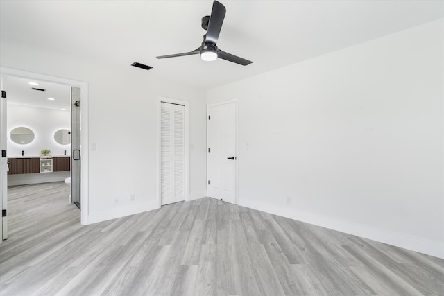 unfurnished room featuring ceiling fan and light wood-type flooring