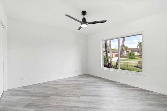 empty room featuring ceiling fan and light wood-type flooring