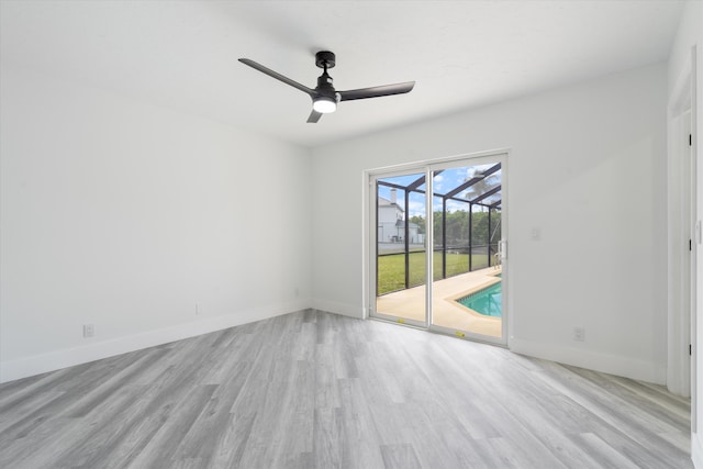 empty room featuring ceiling fan and light hardwood / wood-style flooring