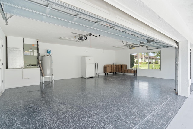 garage with white refrigerator, a garage door opener, water heater, and heating unit