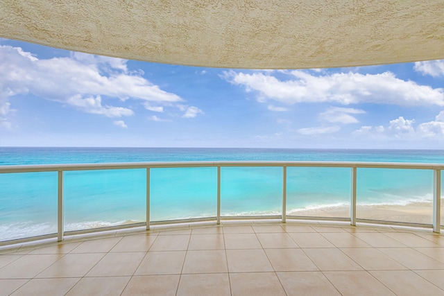 balcony with a beach view and a water view