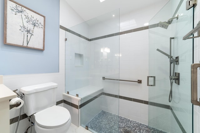 bathroom with an enclosed shower and toilet