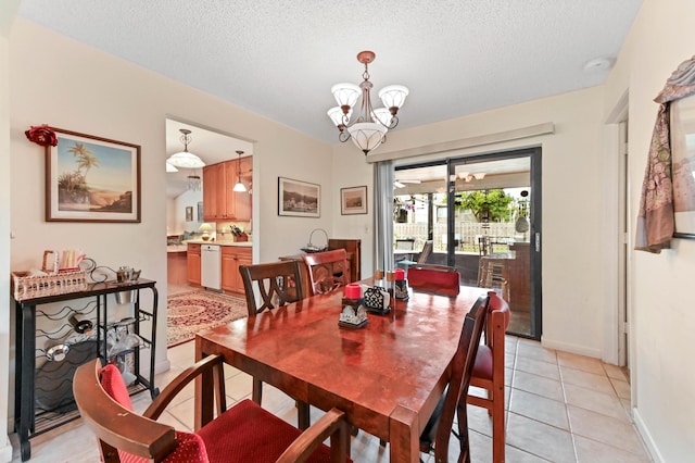 dining area featuring baseboards, a textured ceiling, a chandelier, and light tile patterned floors