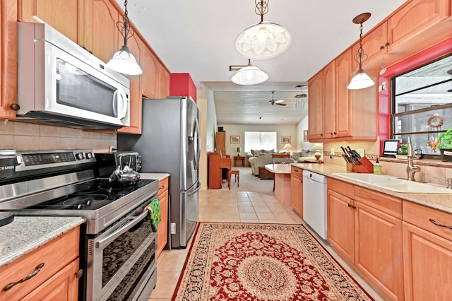 kitchen featuring a sink, a ceiling fan, white appliances, pendant lighting, and light tile patterned floors