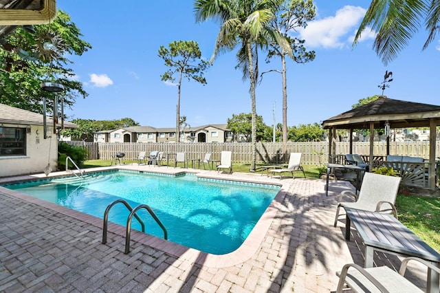 view of pool with a fenced backyard, a fenced in pool, a gazebo, and a patio