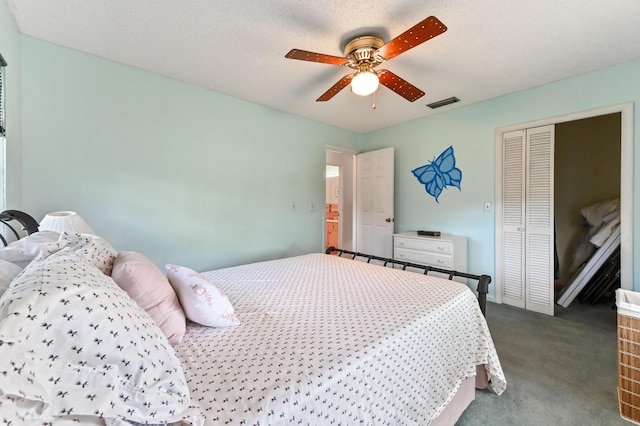 carpeted bedroom with ceiling fan, visible vents, and a closet
