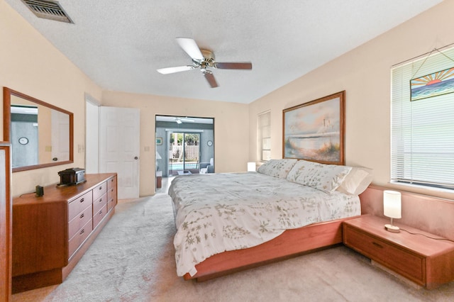 bedroom featuring ceiling fan, visible vents, and light carpet
