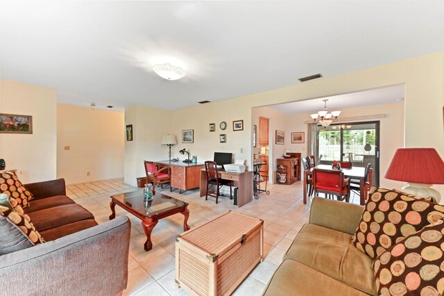 living room with visible vents, light tile patterned floors, and an inviting chandelier