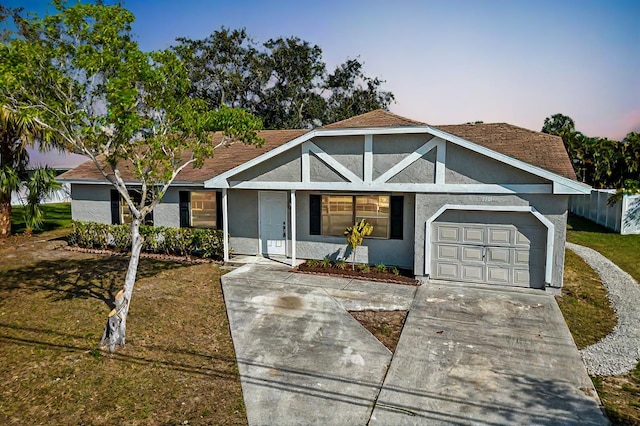 view of front facade with a yard and a garage