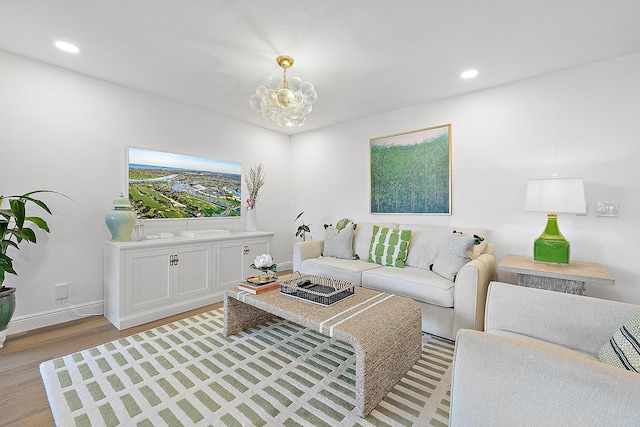 living room with a chandelier and light hardwood / wood-style floors