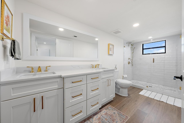 bathroom featuring walk in shower, wood-type flooring, toilet, and vanity