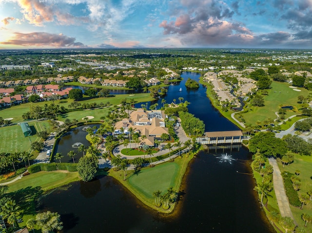 aerial view at dusk featuring a water view