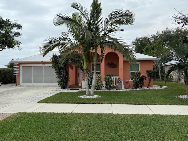 view of front facade with a front lawn and a garage