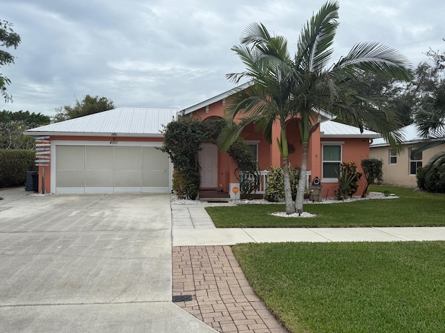 ranch-style home with a front yard and a garage